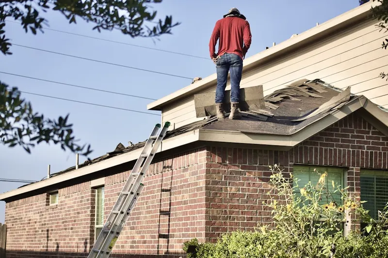 Professional roofer working on a residential roof in Downtown Jersey City